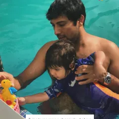 Using a toy, this dad engages his child, making learning a shared and playful experience.