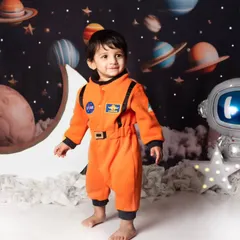 Dressed in a full astronaut suit, this little one is ready for his cosmic adventure in our detailed space-themed studio setup.