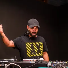 Hyping up the crowd from the DJ booth. Interacting with the audience is a big part of my style, ensuring everyone feels connected to the music and the energy of the night.