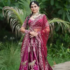 This shot showcases the grand silhouette of the bridal lehenga. As an artist, it's important to understand how makeup, hair, and outfit work together. This unfiltered photo highlights the harmony between the soft glam makeup and the royal magenta attire.