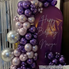 A still shot of the purple and silver balloon arch against a custom backdrop. This style is great for creating a sophisticated focal point at your event where guests can take beautiful photos.