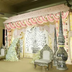 For this ring ceremony puja, I designed an elegant indoor space with soothing pastel decor. The serene setting, featuring a beautiful tree-of-life backdrop and silver thrones, provided a perfect backdrop for the sacred rituals.
