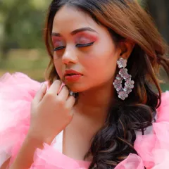 This shot focuses on the eye makeup with the model's eyes closed. It highlights the smooth blend of the pink shadow and the clean application of the winged eyeliner.