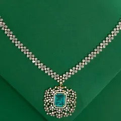 For a touch of modern luxury, I offer pieces like this stunning American Diamond and emerald-style necklace. The brilliant-cut stones are set in a floral pattern, leading to a magnificent centerpiece that makes a bold statement. This is the perfect accessory for cocktail parties or formal receptions.