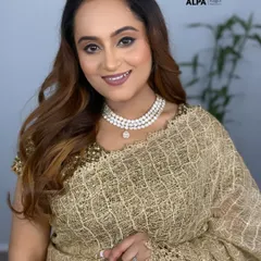 An elegant look for a party or wedding function. The makeup features soft, shimmery eyes and a flawless base that doesn't settle into fine lines.