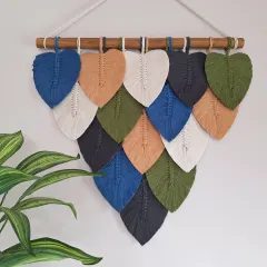 We love bringing the textures and colors of nature into your home. This macrame leaf wall hanging is handcrafted with natural cotton and can be customized with your favorite color palette to create the perfect earthy, cozy vibe for your living room or bedroom.