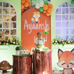 The birthday boy sitting on a tree stump pedestal, interacting with his magical woodland themed first birthday setup. I ensure my designs are safe and accessible for children to enjoy.
