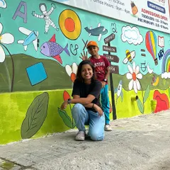 Me and my little helper posing in front of the completed school mural. It was a large project that was so much fun to bring to life.