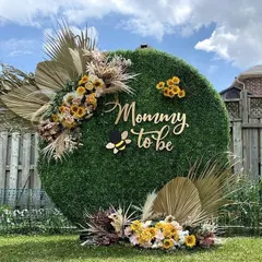 A unique "Mommy to Bee" baby shower theme. I used a round moss wall as the backdrop, decorated with dried palms and sunflowers for a natural, rustic feel.