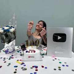 Celebrating a huge milestone: receiving my Silver Play Button from YouTube for reaching 100,000 subscribers! I even made a special YouTube-themed cake to celebrate.