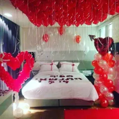 For a truly immersive experience, I can cover the entire ceiling with balloons. This dramatic red and white setup for Valentine's Day or an anniversary creates a stunning visual and includes a heart-shaped balloon sculpture.