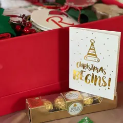 Christmas begins with a box of joy! This Secret Santa hamper for kids is filled with Ferrero Rocher, a personalized ornament, and other festive goodies.
