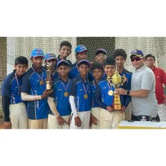 Our coach stands proudly with the victorious U-14 Blue team after their tournament win.