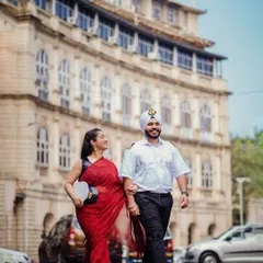 Anchored in love, Kanwaldeep and Avneet walk arm-in-arm through the streets of Colaba. His merchant navy uniform and her elegant red saree create a beautiful contrast against the old-world architecture of Mumbai.