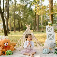 A little gentleman enjoying his picnic. The beautiful park setting and soft sunlight create a perfect backdrop for this charming outdoor session.