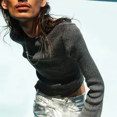 Another look from the Myntra FWD shoot, focusing on texture and form. The combination of a metallic knit top and silver pants is highlighted with strong sunlight, creating a futuristic and high-fashion editorial look.