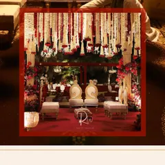 The mandap, set for the ceremony. The combination of a rich red carpet, ornate seating, and the magnificent floral ceiling creates an atmosphere of pure royalty.