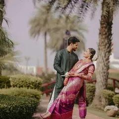 A graceful portrait of a South Indian couple. The groom dips his bride, dressed in a beautiful silk saree, showcasing the elegance and romance of traditional Indian weddings.