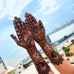 A gorgeous bridal mehendi with the Mumbai sea link in the background. The design features elegant elephants and peacocks, blending traditional art with the modern vibe of a city wedding.