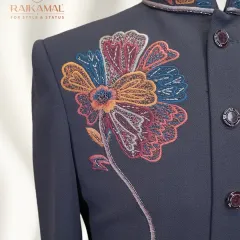 I love blending traditional techniques with modern artistry. This Indo-Western jacket features a bold, multi-colored floral embroidery design on a deep navy blue fabric, creating a statement piece that is both artistic and elegant. This is a perfect example of fusion wear for a reception or festive event.