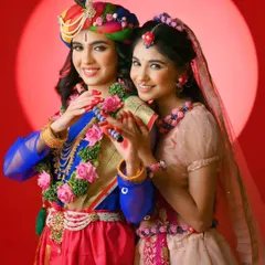 A joyful portrait from a Radha Krishna themed shoot for Janmashtami. The vibrant colors and happy expressions capture the festive and divine spirit.