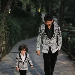 Style runs in the family. We create coordinated father and son outfits, like this matching set of heavily embroidered tuxedos, perfect for making a statement and creating lasting memories at any formal wedding function.