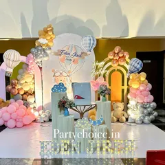 A dreamy pastel teddy bear and hot air balloon theme. This beautiful setup features multiple pedestals, cloud and moon props, and a soft, retro color palette for a gentle and sweet celebration.