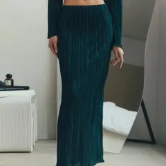 A view of the pleated maxi skirt from the two-piece set, showing its full length and the beautiful texture of the fabric.