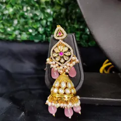 The matching jhumka earring, combining traditional kundan with modern pastel pink for a beautiful fusion look.