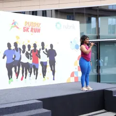 On stage, guiding participants through a fun and effective Zumba warm-up at a 5K run event. My goal is to make fitness accessible and enjoyable for everyone.