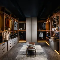 We believe a wardrobe should be a luxurious dressing space. This walk-in closet is designed with clean lines and warm, ambient lighting, featuring a mix of open shelving and drawer units to create a perfect, organized solution for your entire collection.