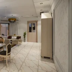 An open-concept view showing the flow from the dining area to the living space. This perspective highlights the spacious layout, consistent marble flooring, and classic wall paneling that create a cohesive and expansive feel.