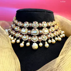 True beauty lies in the details. This three tier Kundan choker merges centuries old craftsmanship with a fresh silhouette, while the delicate pearl drops add a final touch of enchantment and grace.
