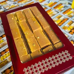 Add a splash of colour with our festive red boxes. This option is perfect for making your gifts pop, shown here holding our delicious Mysore Pak. It's an excellent choice for Diwali and other vibrant celebrations.