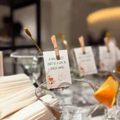 "A balanced diet is a gin in each hand." Another one of our playful custom glass tags, clipped to a classic martini glass. These small details are what make our service unique.