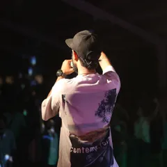 On the mic, connecting with the crowd. It's not just about the music, it's about the shared experience and making sure everyone is part of the show.