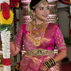 The complete look in the temple setting. The makeup, hair, and saree all come together to create a look that is both traditional and breathtakingly beautiful.