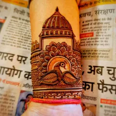 A wrist cuff design showing a peacock in front of a large dome, with a lotus base. The details create a beautiful 3D effect.