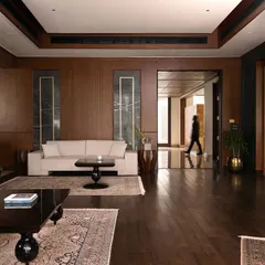 The interior of the Mehalin Farm den, showing the rich wood paneling and its connection to the wider circulation spaces. The design prioritizes an open feel while maintaining distinct functional zones.