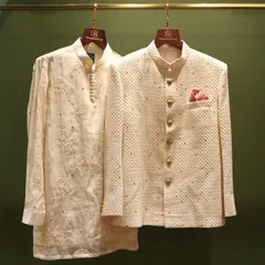A classic groomswear combination. This pairing features a subtly embroidered kurta and a textured bandhgala jacket, perfect for a sophisticated and timeless wedding day look.