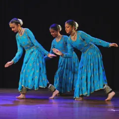 Three of my senior students executing a synchronized movement, highlighting the precision and alignment we practice in our traditional Kathak choreography.