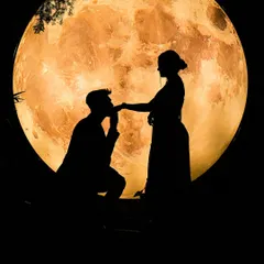 A classic pre-wedding silhouette. The groom-to-be kneels before his partner against a large, illuminated moon, creating a timeless and romantic proposal scene.