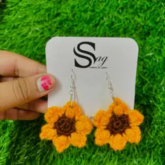 A closer look at the detailed stitching on my sunflower crochet earrings. I use soft yarn to create each petal, making them both beautiful and comfortable to wear.