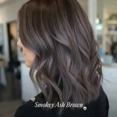 This is our Smokey Ash Brown, a modern and cool-toned option. It's perfect for neutralizing brassy tones and achieving a sophisticated, matte-like finish. We cut the hair into a stylish lob to complete this chic, contemporary look.