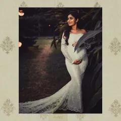 Another shot from the maternity shoot, showcasing the beautiful silhouette of the white lace gown against a garden backdrop.