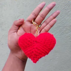 A plush red crochet heart keychain, perfect for Valentine's Day or as a gift for a loved one.