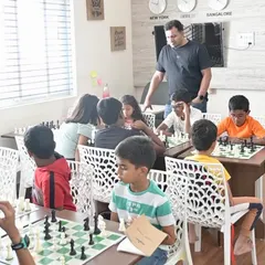 We keep our batches small to ensure every child gets personal attention. Here, one of our FIDE-rated coaches observes a session, ready to provide guidance and help students think through their moves.