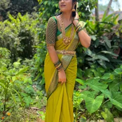 A full-length view of the client in her elegant green saree and beaded blouse, a testament to simple and beautiful styling.