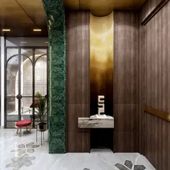 This entryway makes a bold statement with a dramatic green marble arch and rich wood paneling. The design incorporates floral marble inlays and a sculptural console to create a chic and cozy atmosphere.