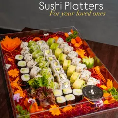 A beautifully arranged vegetarian sushi platter, presented in a clear acrylic box that makes it perfect for gifting or as an elegant addition to your party. This platter features a variety of rolls, including cucumber, avocado, and more.